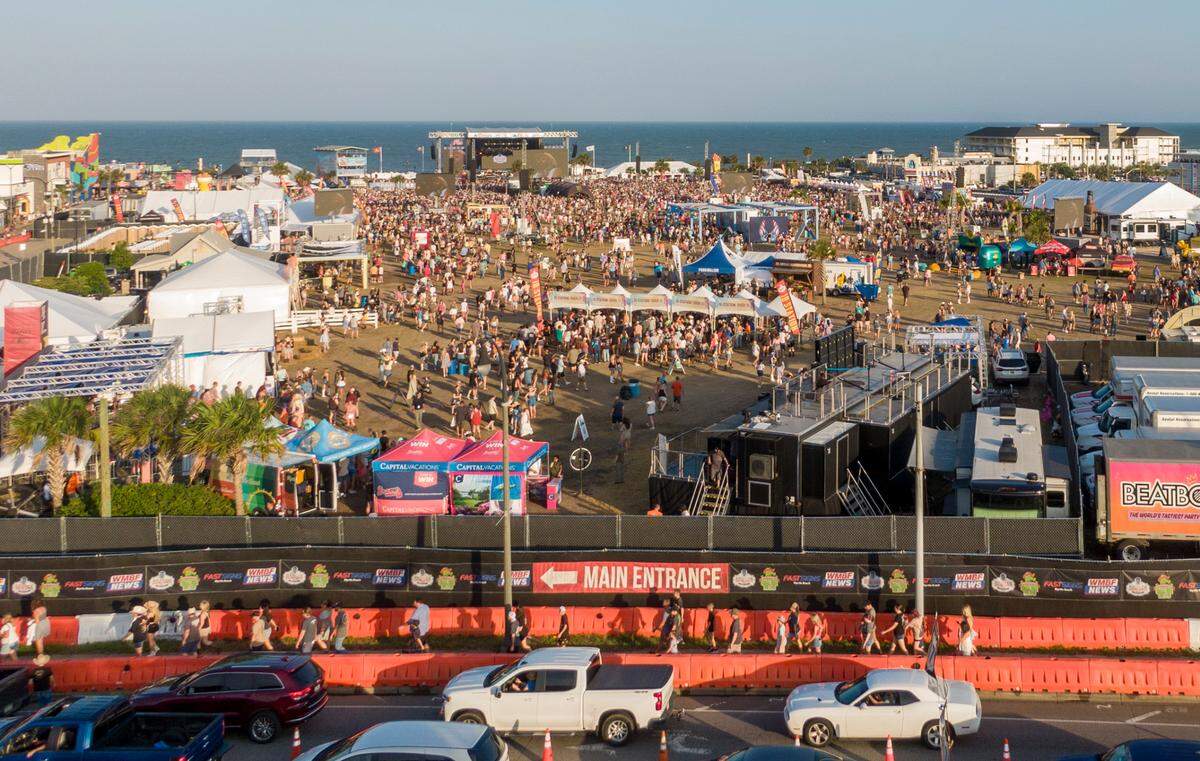 Country music fans arrive for the first night Carolina Country Music Fest 2024. The four day event is expected to draw 30,000 each night at the Burroughs and Chapin Pavilion Place in Myrtle Beach, S.C. Thursday, June 6, 2024.