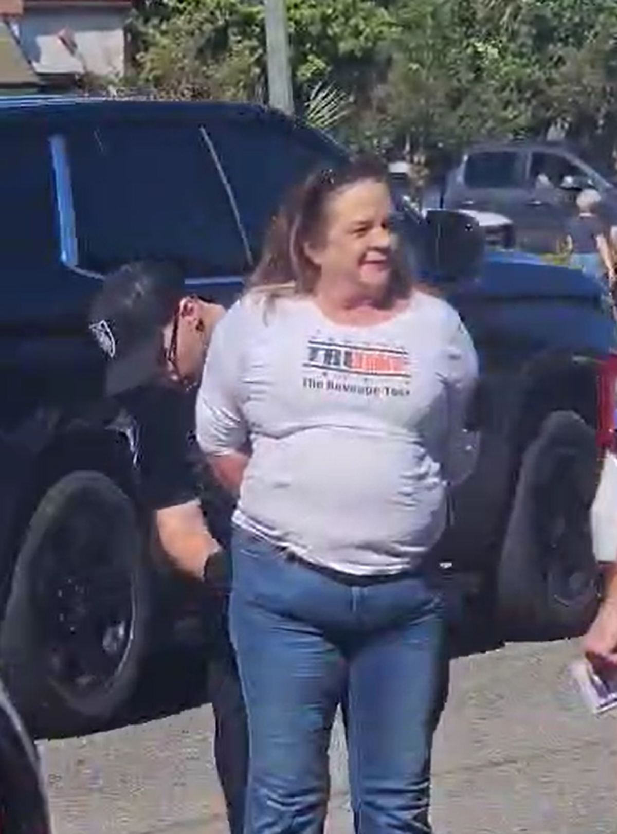 Mary Moriarty was arrested after brandishing a firearm at the Myrtle Beach “No Kings” protest on Saturday, Oct. 18, 2025. Video of her arrest shows her wearing a shirt reading “Trump, The Revenge Tour” as officers speak to her and secure handcuffs.