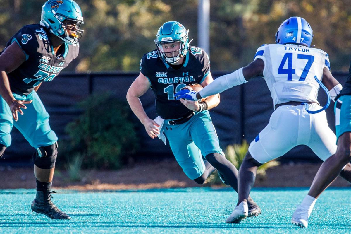 Coastal’s Bryce Carpenter runs past Georgia State defenders. Coastal Carolina University host Georgia State for homecoming on Saturday. Nov. 13, 2021.