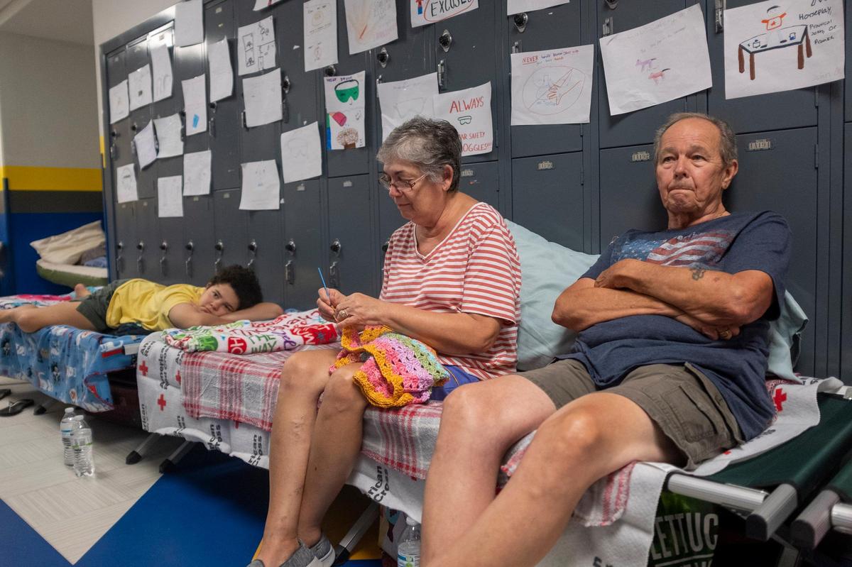 Gordon and Dina Reynolds with their 11-year-old grand daughter Abby sit on cots in the hall way of the North Myrtle Beach High School that is currently being used as a Red Cross evacuation shelter. The Grand Strand is waiting the arrival of Hurricane Doran that should be off the coast within the next day. Wednesday Sept. 04, 2019.