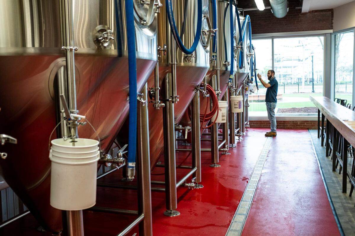 Christophe Perdu, the head brewer at Grand Strand Brewing Co. in Myrtle Beach, checks the clarity of a his beer in Myrtle Beach. February 12, 2021.