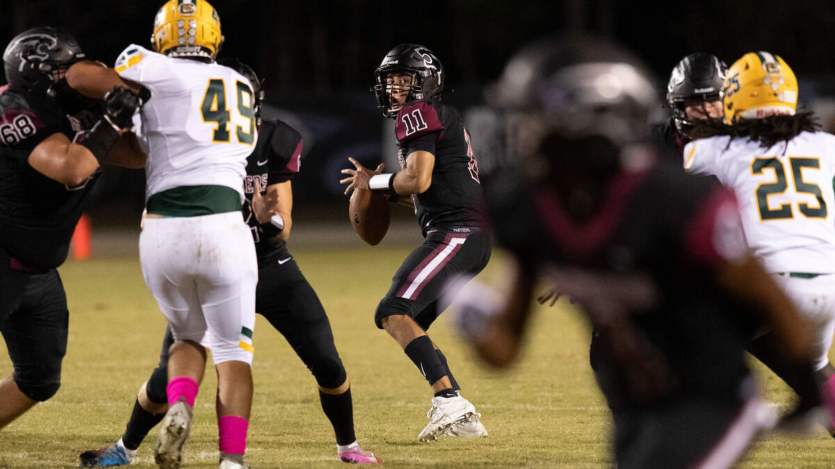 Carolina Forest quarterback Kyle Watkins (11) zeros in on a TD pass to DJ Admill during 1st quarter action against Conway Friday at Carolina Forest High School.