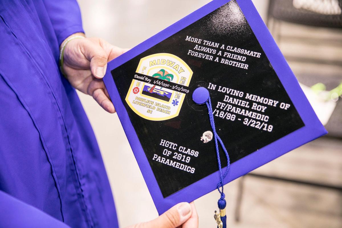 Bill Rosas, a friend and classmate of Midway Firefighter Daniel Roy, holds his graduation cap with a tribute to Roy on it. Horry Georgetown Technical College posthumously honored the Roy during graduation ceremonies today with his EMT/Paramedic degree. May 14, 2019.