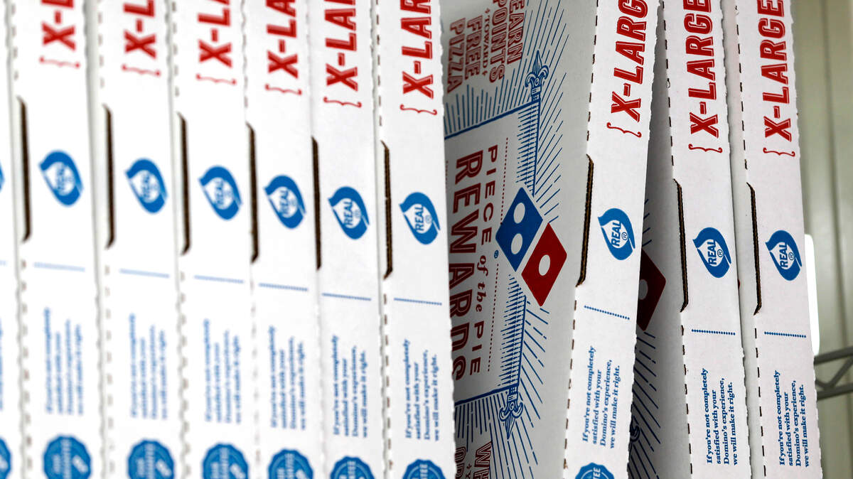 FILE- This Oct. 27, 2016, photo shows Domino's Pizza boxes at one their locations, in Hialeah, Fla. The pizza chain said Monday, April 16, 2018, that its drivers can meet customers at beaches, parks and landmarks to hand over pizza, cheesy bread or chicken wings. In all, Domino’s said it can deliver to 150,000 outdoor locations in the United States, including under the Gateway Arch in St. Louis, or the beaches of Siesta Key, Fla. (AP Photo/Alan Diaz, File)