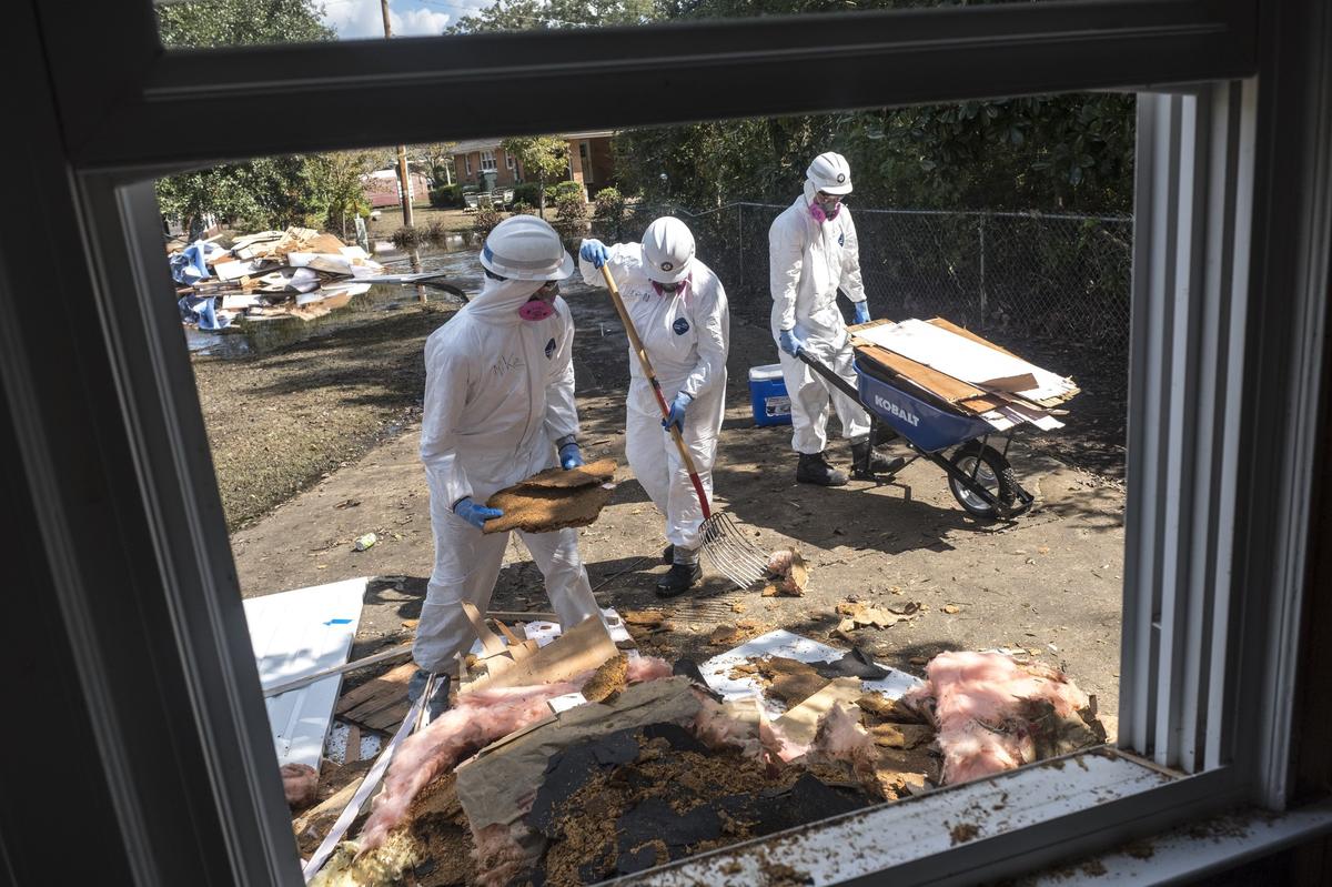 Americorps volunteers from across the United States assist in mucking out the home of Joey Tyler on Sherwood Drive on Monday.The many volunteers that are helping with flood victims are organized under the Waccamaw VOAD (Voluntary Organizations Active in Disasters.) October 1 2018.