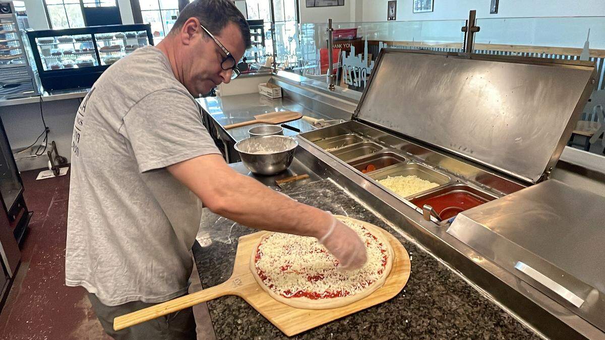 Arben Rroku, owner and manager of New York Pizza in Myrtle Beach, makes a pizza. The eatery opened on the Grand Strand in December 2023.