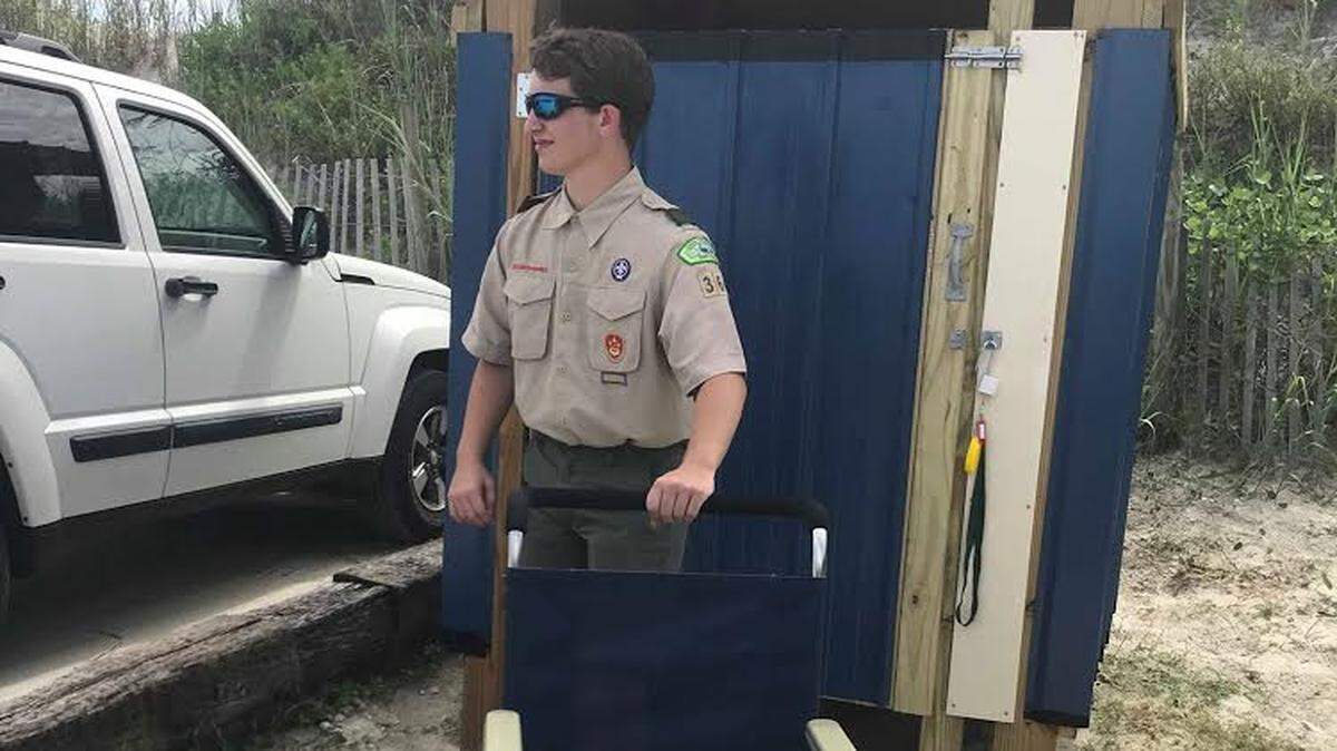 Jake Birchmeier shows off the beach wheel chair and storage building he provided for the Town of Pawleys Island as an Eagle Scout project.