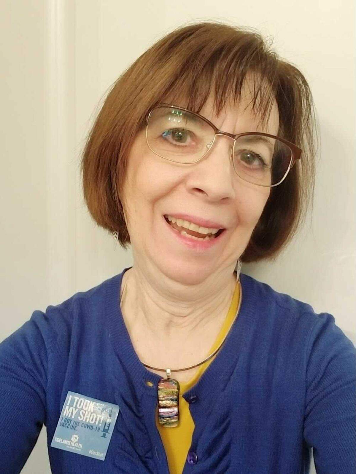 Mary Wilson of Myrtle Beach shows off a sticker after getting her COVID-19 vaccine. She held off on getting the shot until she saw others’ experiences because she’s had adverse reactions to medication in the past.