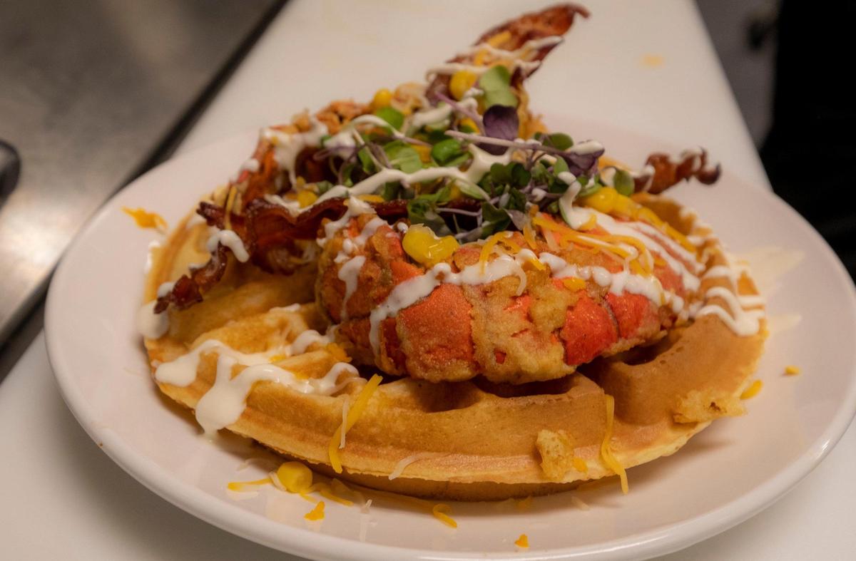 Mimosas serves a specialty brunch menu including Fried Lobster & Waffles, which includes apple-smoked bacon, cheddar, greens and corn. June 13, 2023.