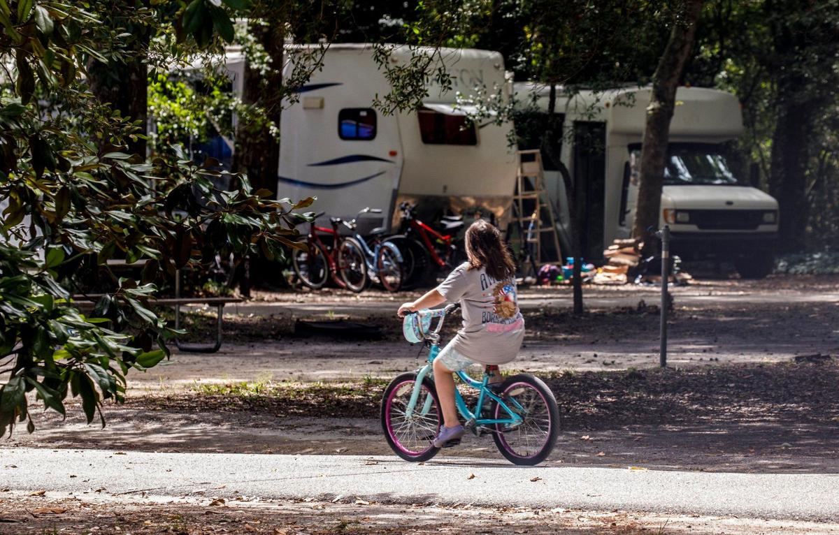 A girl rides her bike through the camp ground at Myrtle Beach State Park. Sept. 4, 2024.