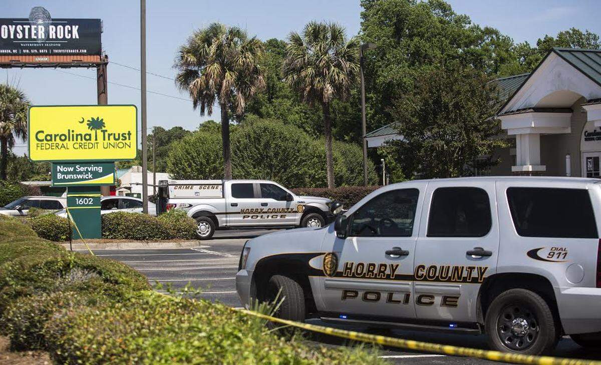 Horry County police respond to a bank robbery at the Carolina Trust Federal Credit Union in Little River, S.C. on June 6, 2018.