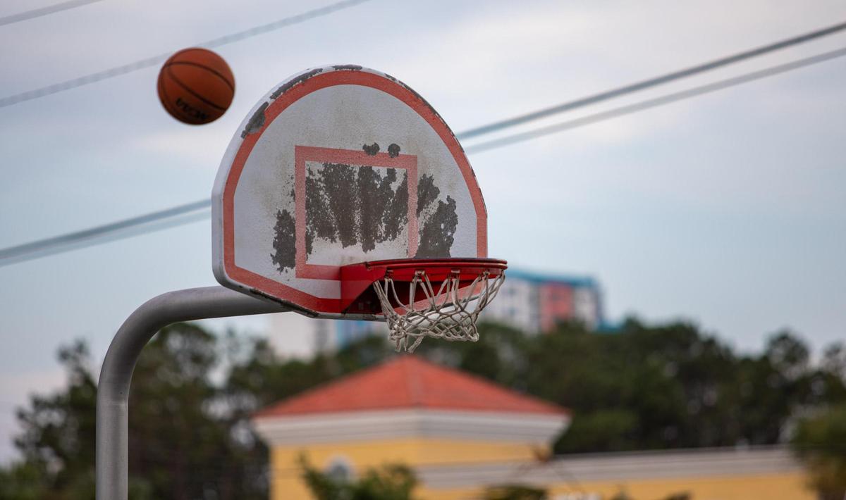 Myrtle Beach residents participate in a game of pick-up basketball on the basketball court at Midway Park in Myrtle Beach Sunday afternoon.