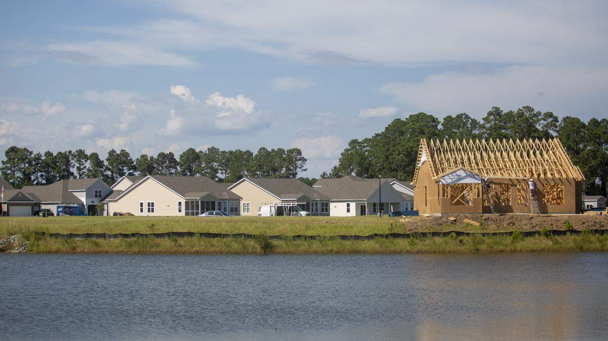 Construction crews work on a house in Cameron Village in Socastee on Friday.