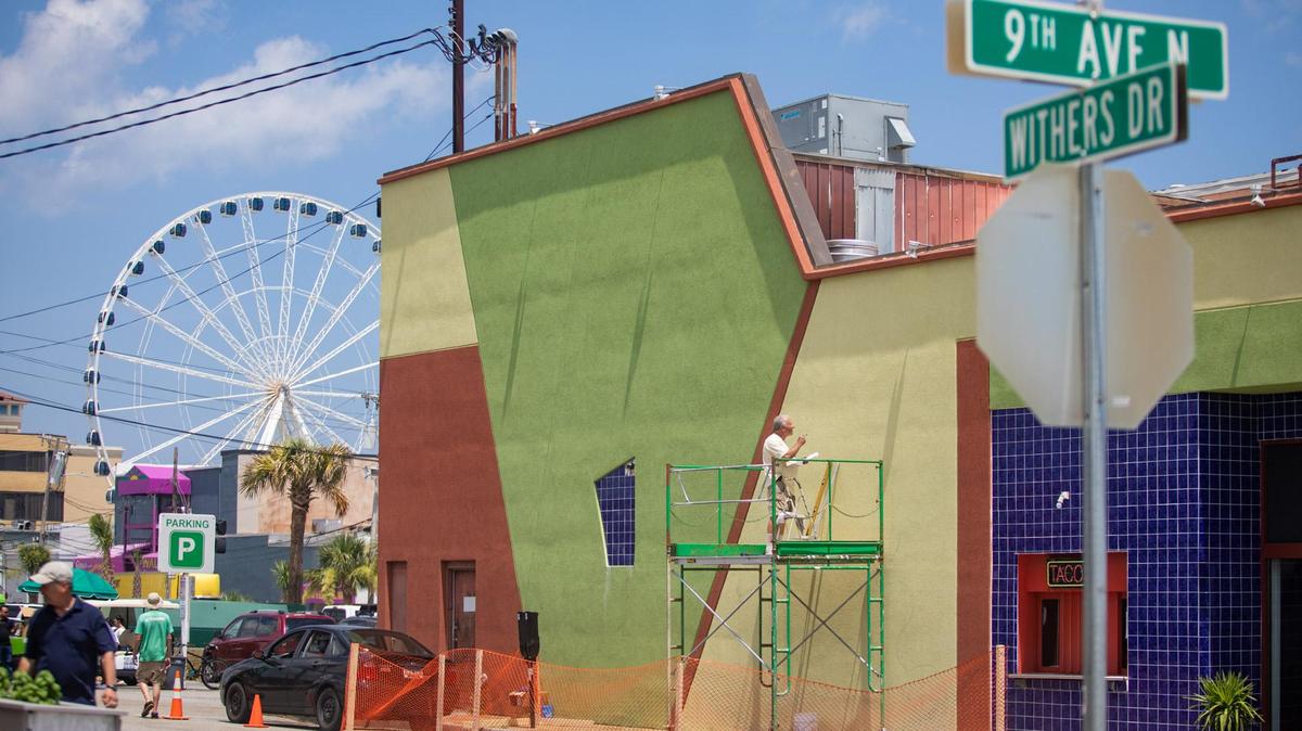 Rick Forest of Little River sketches out a mural on the side wall of Gordo’s Tacos & Tequila Monday afternoon in Myrtle Beach.