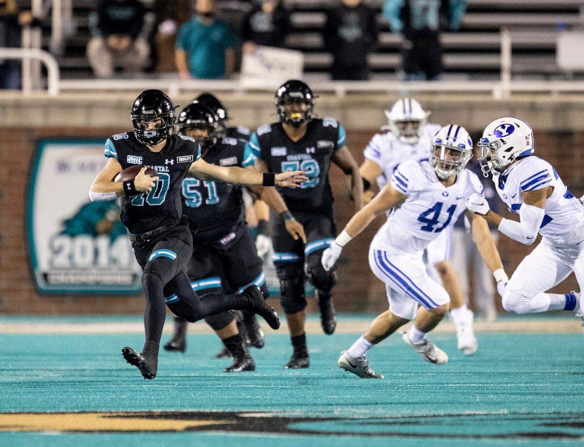 Coastal Carolina quarterback Grayson McCall breaks free from Brigham Young defenders on Dec. 5th. Dating back to his high school days at Union County’s Porter Ridge, running has always been a big part of McCall’s game.