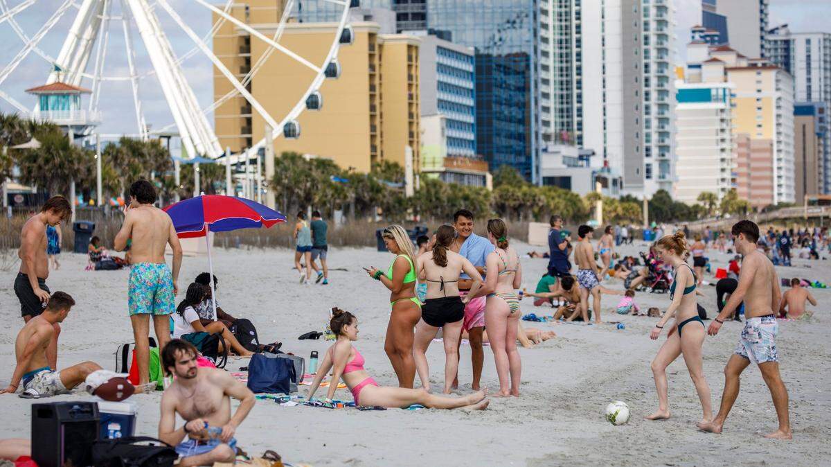 Students play games and hang out on the beach in the downtown section of Myrtle Beach, S.C. Thousands of students visit the Grand Strand from late February to early April from Spring Break every year. March 17, 2022.
