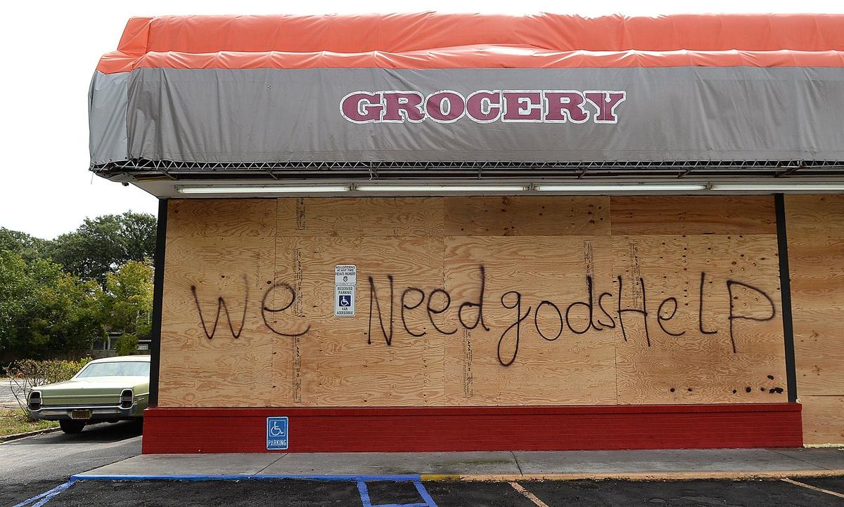 The sign at Mona Lisa Beverage pleads for help from the storm.Messages were left by business owners on the store fronts along Hwy 17 Business in Myrtle Beach on Thursday, September 13, 2018, as they waited for Hurricane Florence to make landfall.