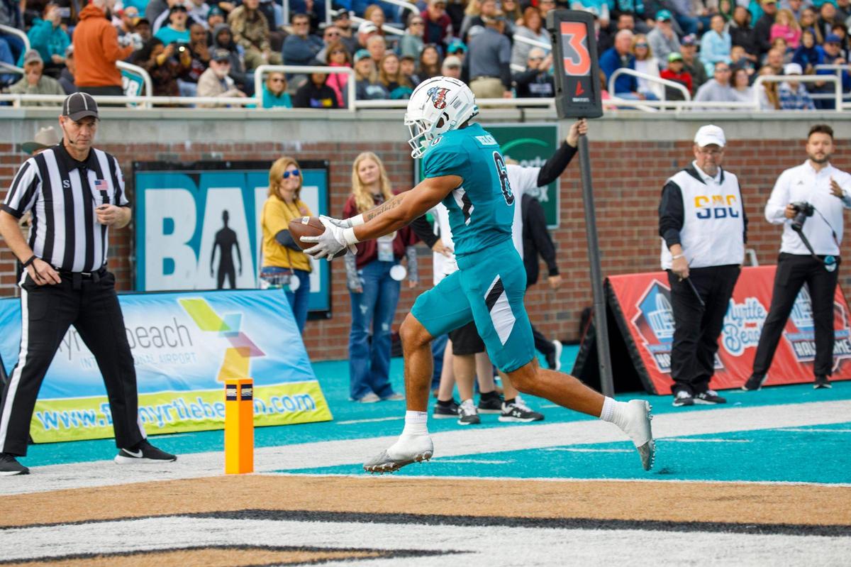 Coastal’s Jaivon Heiligh receives a pass for a touchdown against Texas State. Coastal Carolina played Texas State in college football. The Coastal Carolina Chanticleers played the Texas State Bobcats in a Sun Belt Conference NCAA FBS college football game in Conway SC. Nov. 20, 2021.