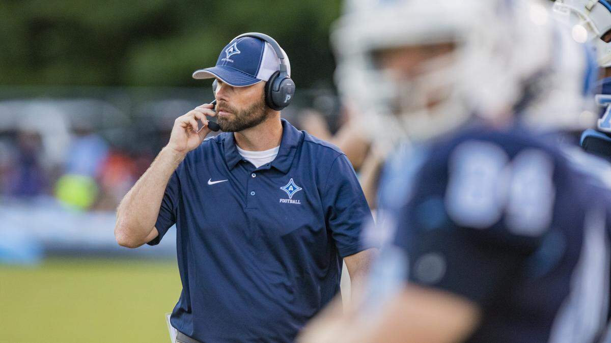 Aynor head football coach Jasson Allen adjusts his headset ahead of the kickoff against the Waccamaw Warriors Friday night in Aynor.