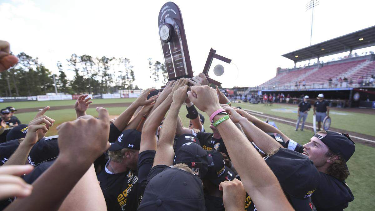 Coastal Carolina players hold up the trophy after winning the Sun Belt tournament championship in May in Lafayette, La.