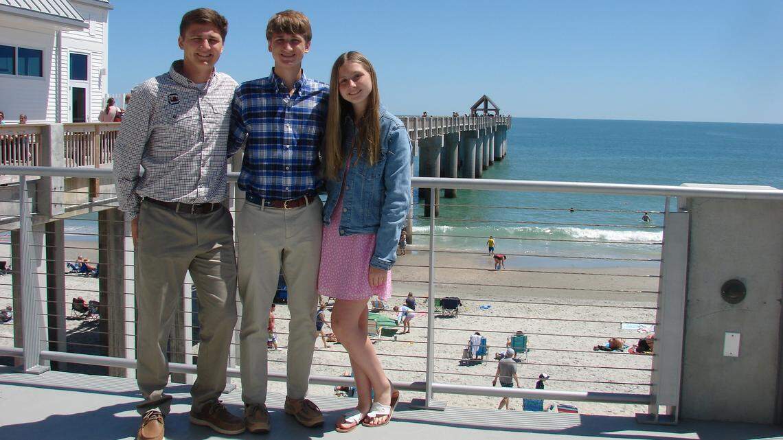 Liam, Aden and Bella Perry stand on the Surfside Beach Pier where the second location of Perry’s Bait & Tackle will open. The siblings were left the business after their mother, Jessica Hill Perry, was killed by their father in 2017. April 14, 2024
