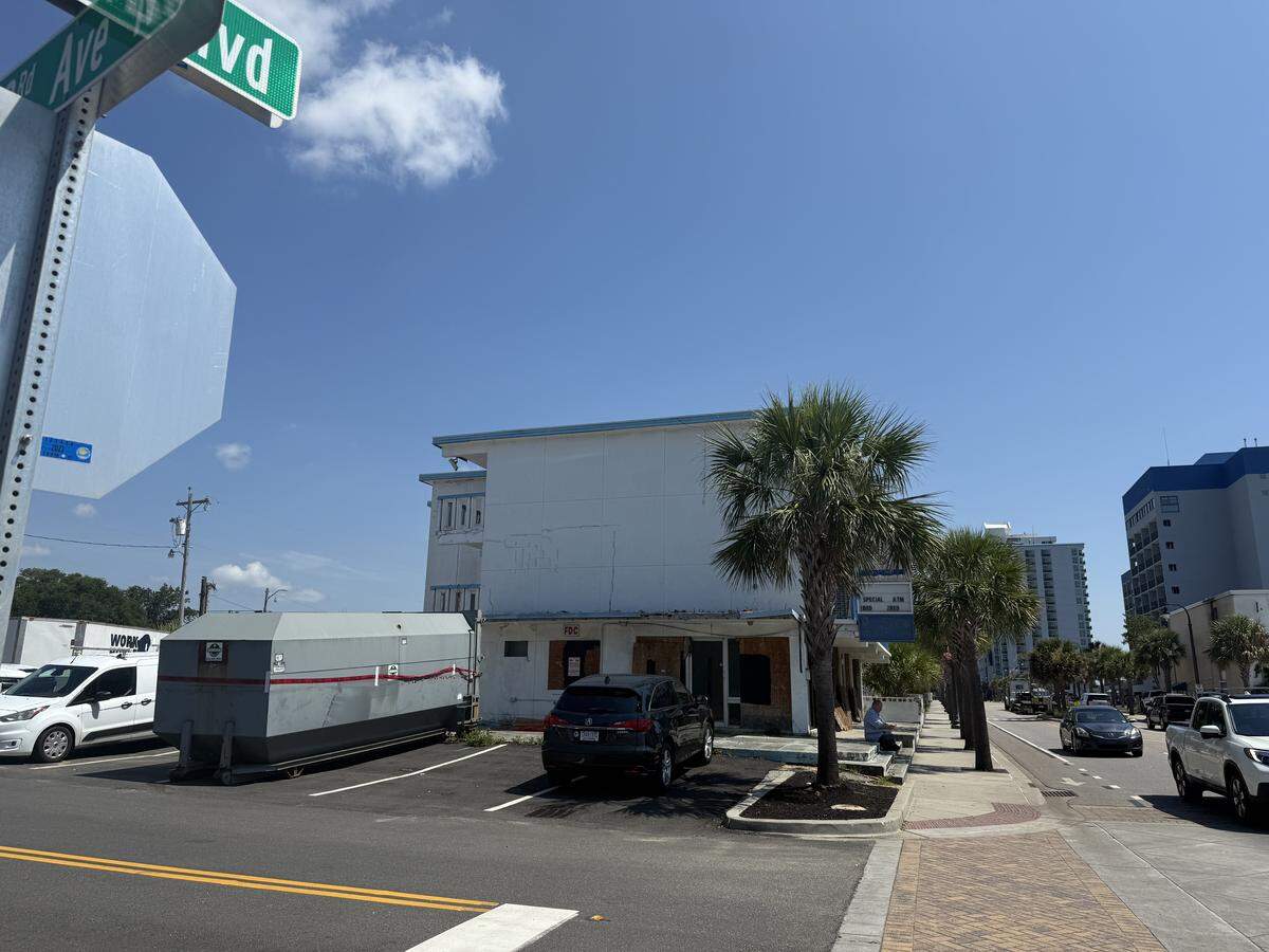 Crews worked at the Coral Sands Motel on Ocean Boulevard on Monday morning. The motel was previously boarded up with plywood for months. 