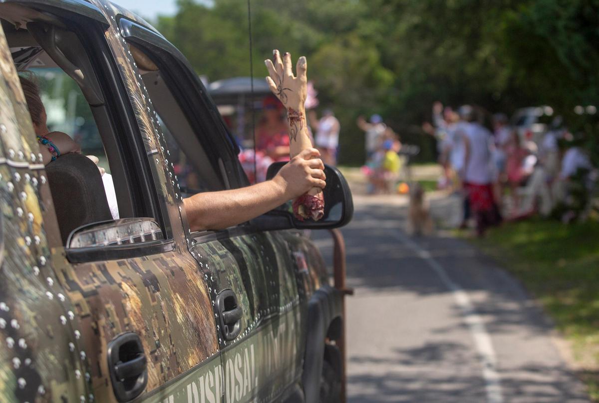 A "zombie" themed float moves by spectators in Pawleys Island during the 2018 Pawleys Island 4th of July Parade.