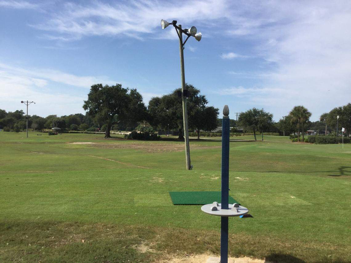 A tee box has a drink holder and is near a light pole with speakers playing music Monday at The Aero Club Short Course par 3 golf facility, which opened Friday on U.S. 17 Business near Myrtle Beach International Airport. It is on the site of the former Midway Par 3, which closed in 2017.