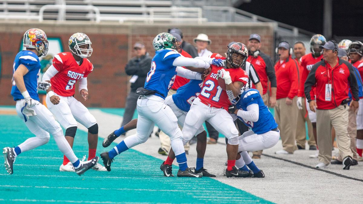 Hartsville senior running back Tiyon Evans gets pushed out of bounds as the South All Stars take on the North All Stars in the 2018 Touchstone Energy Cooperatives North vs. South Bowl game Saturday at Brooks Stadium in Conway.