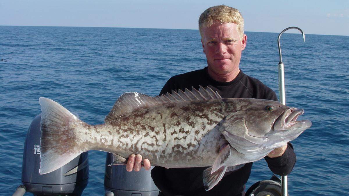 The late Capt. Roger Gales shows off a hefty gag grouper.