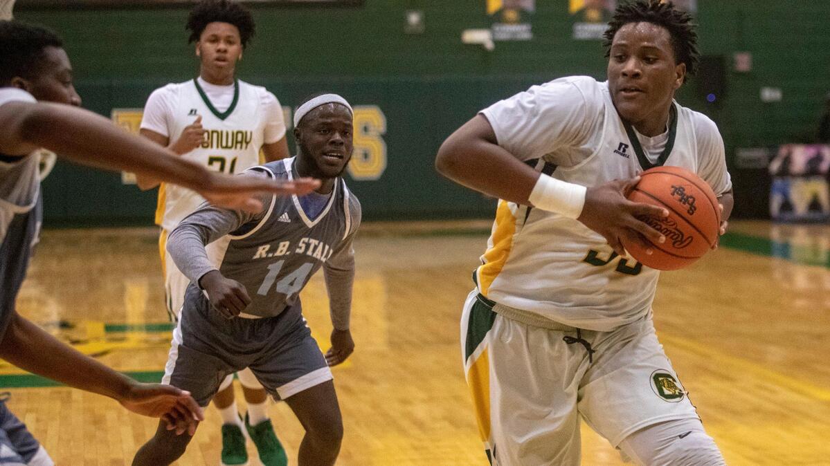 Conway High’s Tonka Hemingway (33) drives the lane for a basket Wednesday against Stall in the first round of the Class 5A playoffs at Conway High School.