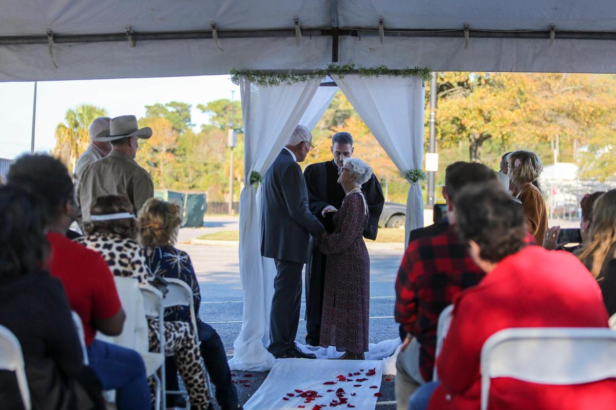 Jane Billedeaux and Harris Putnam, both 82-years-old, married Saturday in the parking lot of the Walmart where Billedeaux works as a host. Nov. 13, 2021.