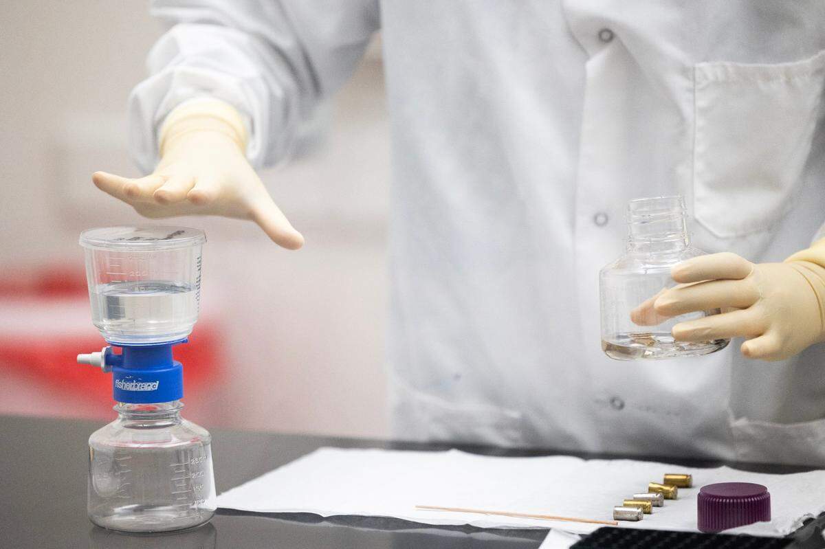 SLED workers remove possible human DNA that could be used to find who loaded a firearm at their new forensics laboratory on Thursday, April 27, 2023.
