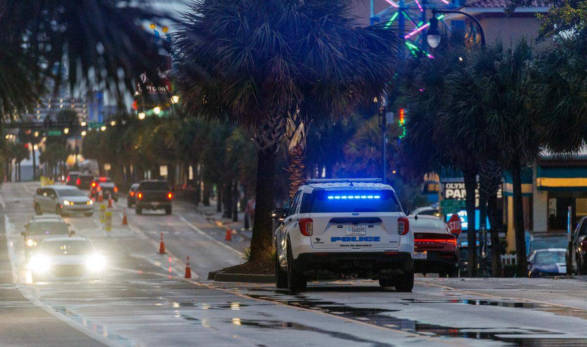 A Myrtle Beach Police vehicle sits in the median of Ocean Boulevard on Friday evening. Downtown Myrtle Beach’s tourist district was relatively quiet for a Summer evening on Ocean Boulevard and the Boardwalk. Storms put a damper on the evening activities but as the skies cleared, visitors returned to enjoy the attractions. Friday, May 30, 2025.