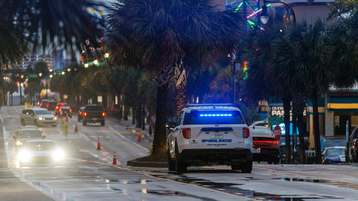 A Myrtle Beach Police vehicle sits in the median of Ocean Boulevard on Friday evening.