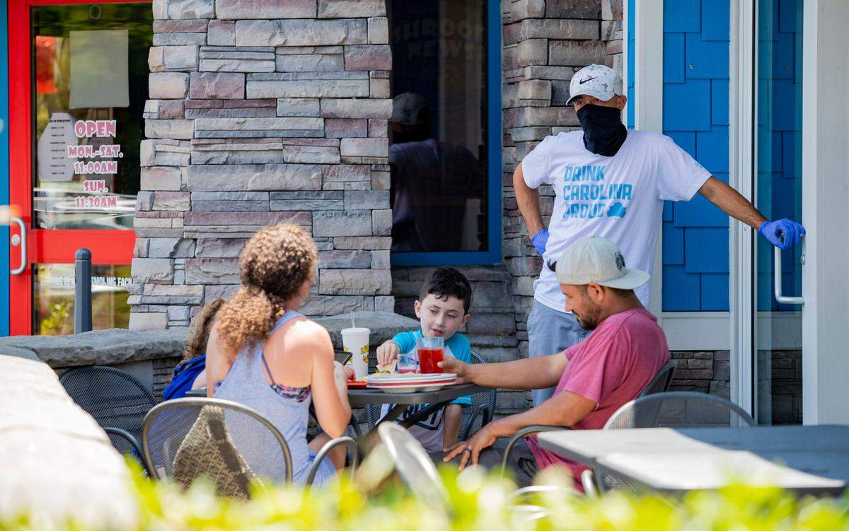 A family dines outdoors at Mellow Mushroom Wednesday afternoon in Myrtle Beach.