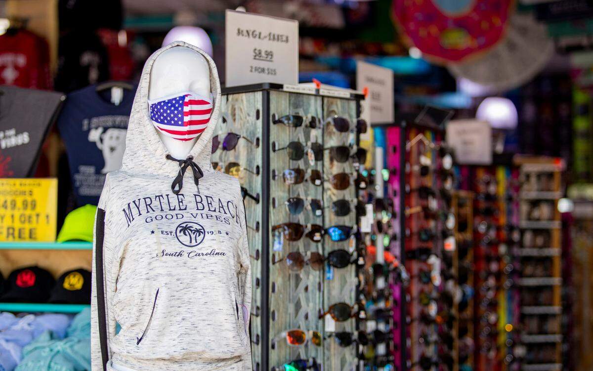 A masked mannequin faces Ocean Boulevard from the entrance to Surf’s Up Beach Shop in Myrtle Beach.