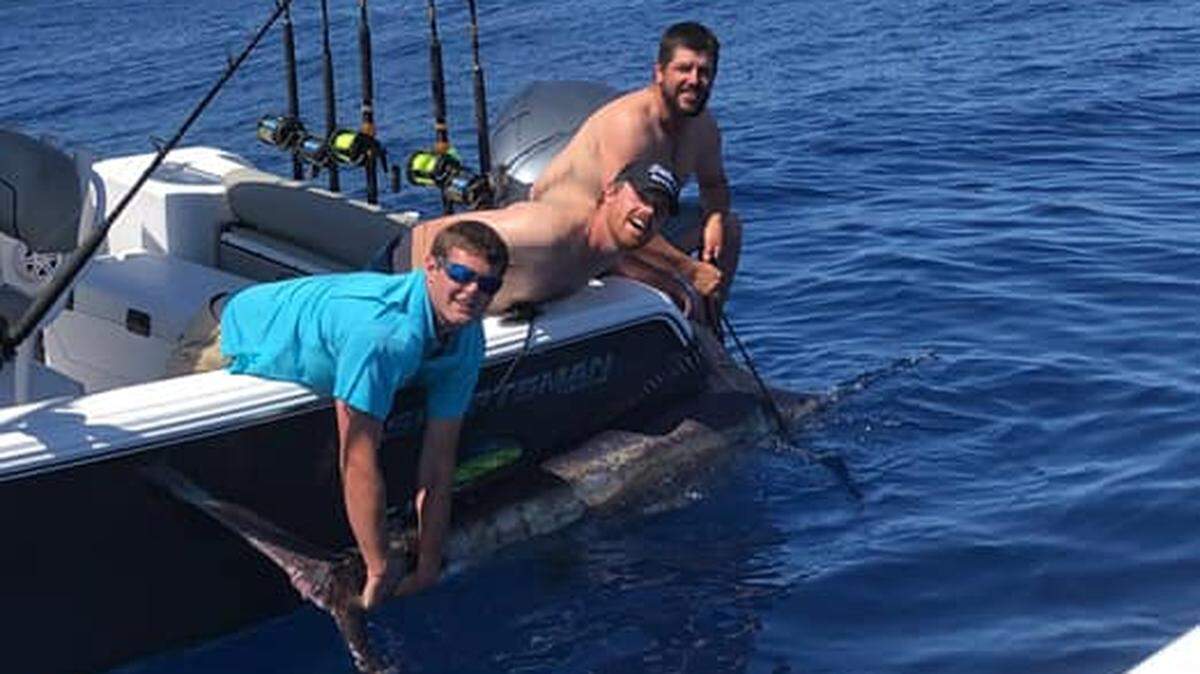 Trey Jordan, Ronald Stalvey and Matt Winburn show off a blue marlin before releasing it 80 miles offshore of Georgetown on April 24.