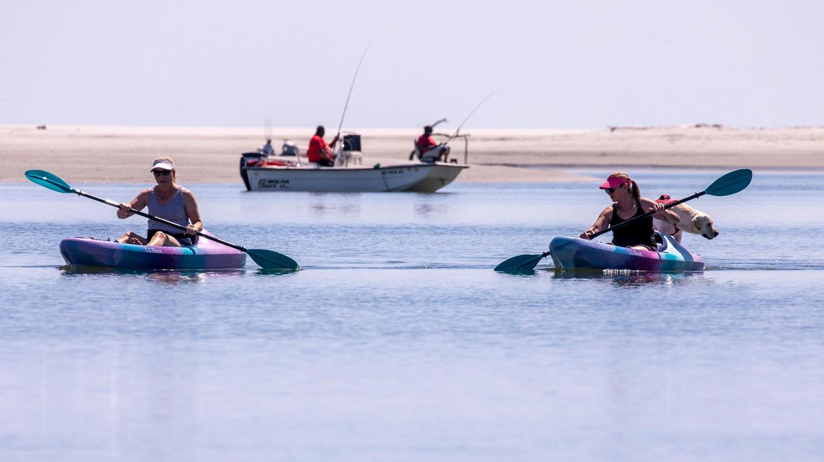 Kayakers and fishermen cruise the waters of Hog Inlet in the Cherry Grove section of North Myrtle Beach moments after the governor lifted the order closing public boat landings. South Carolina Governor Henry McMaster closed public boat landings on March 30th, but reopened them today allowing residents back onto public waterways while following social distancing orders. April 16, 2020