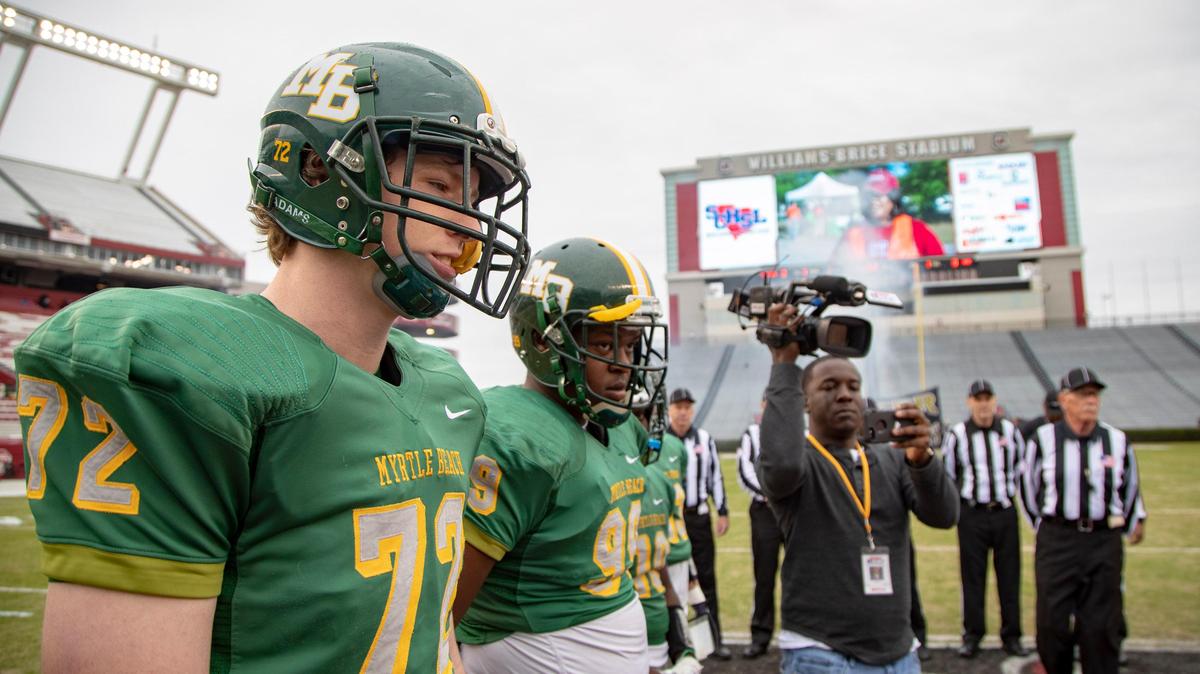 Captains for the Myrtle Beach Seahawks and the Greer Yellow Jackets meet on the 50 yard line Friday at Williams-Brice Stadium ahead of the S.C. Class 4A state championship game. Evan Jumper (72) signed to play at Furman on Wednesday.