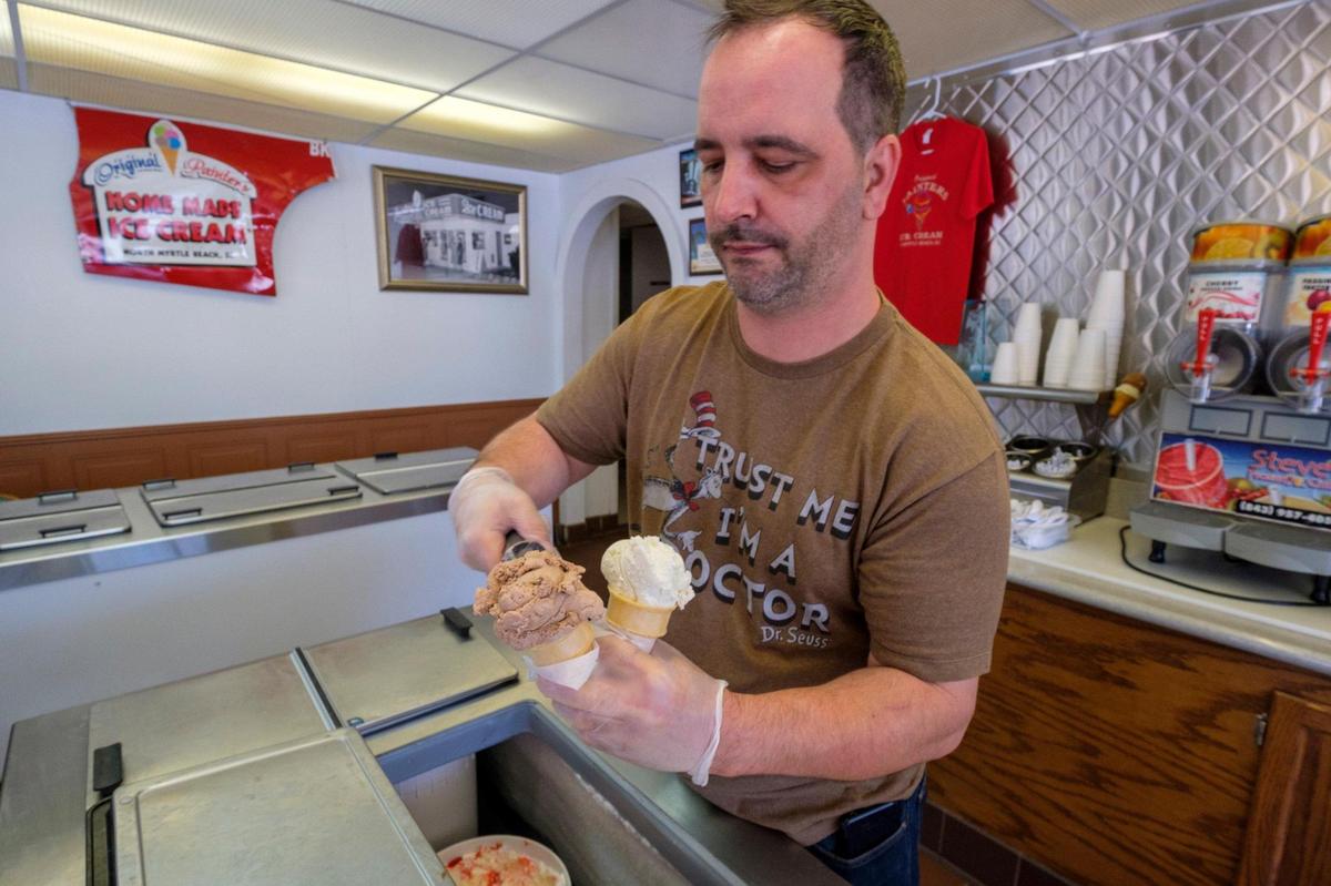 Dominic Munafo serves scoops of ice cream at The Original Painter’s Ice Cream in North Myrtle Beach which opened in 1952. April 22, 2022.