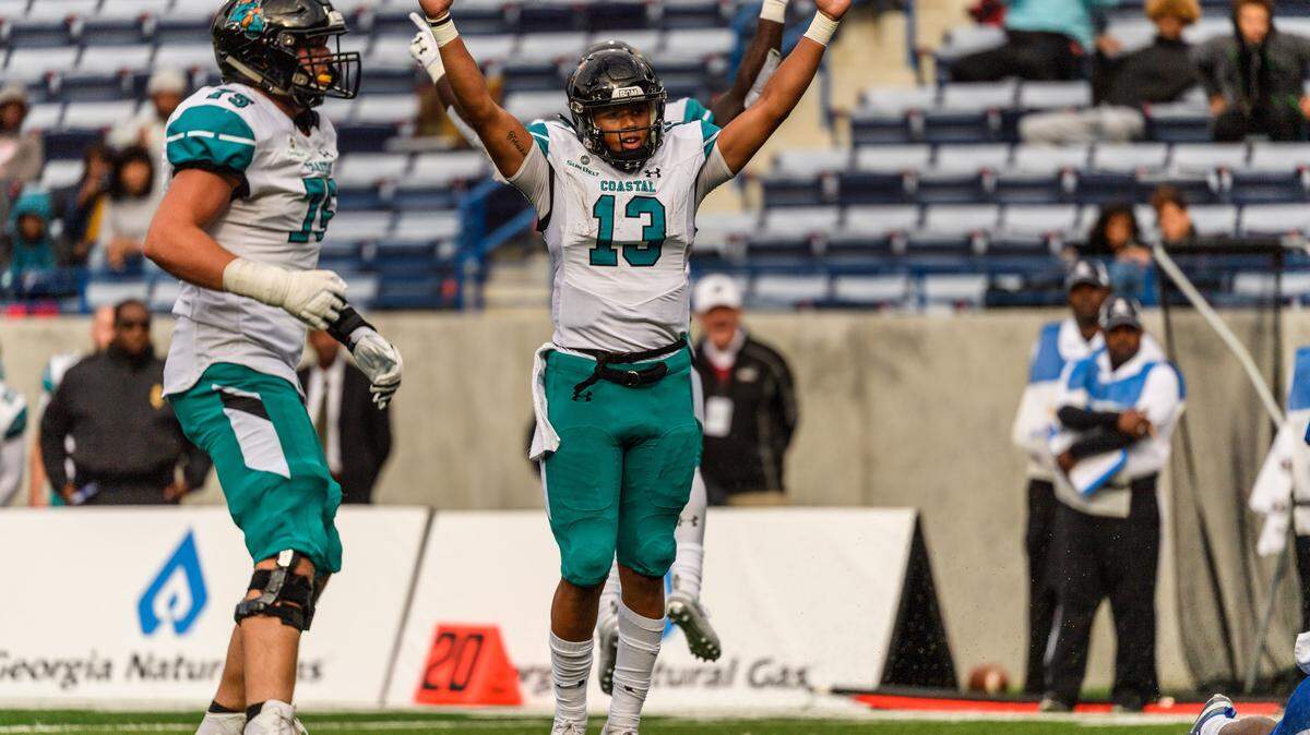 Coastal Carolina freshman quarterback Fred Payton signals a touchdown Saturday in the Chanticleers’ 37-34 win at Georgia State in Atlanta.