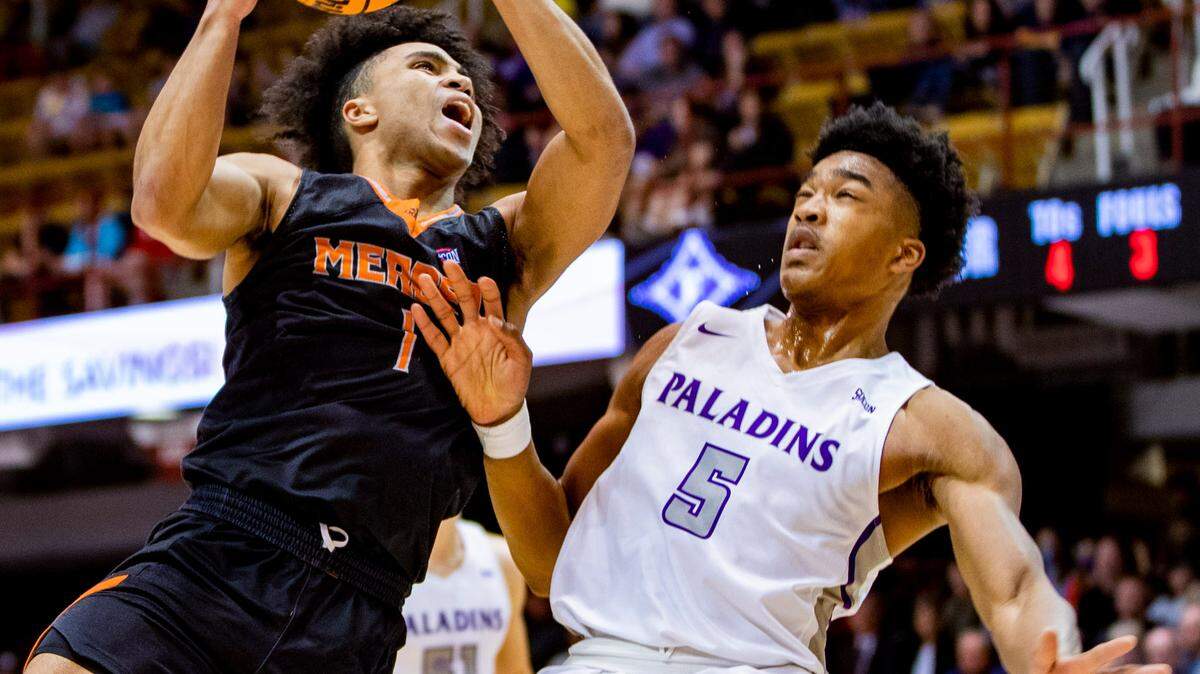 Mercer junior guard Kamar Robertson drives to the net against Furman Saturday afternoon in the SoCon Ingles Basketball Championships at the Harrah’s Cherokee Center in Asheville, N.C.