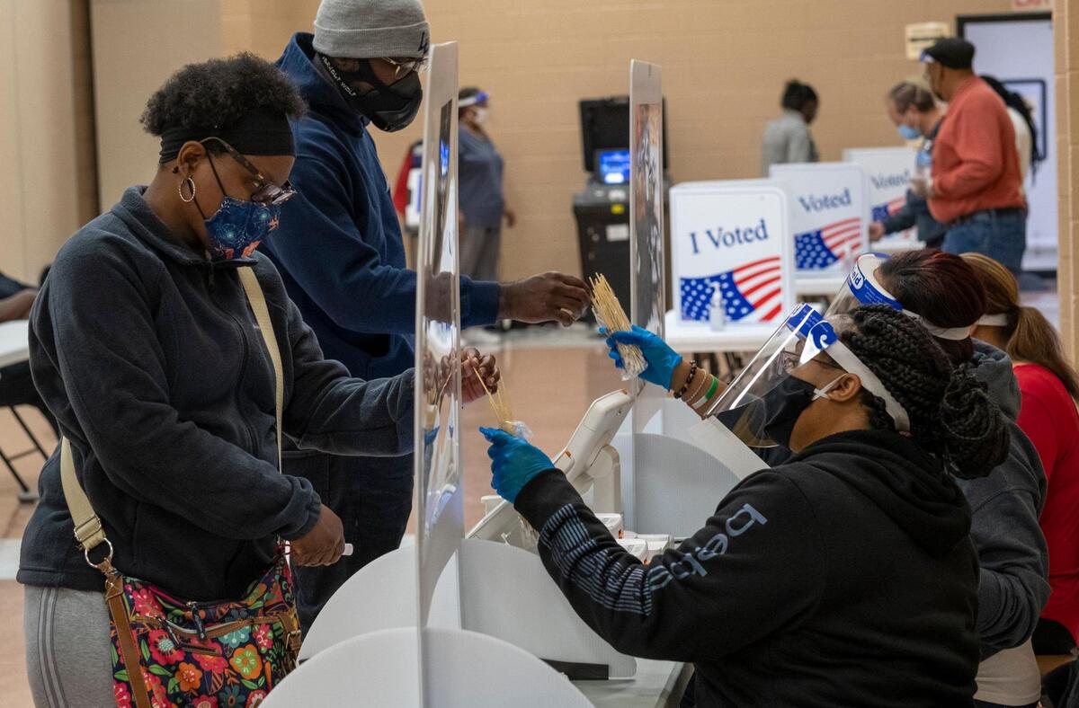 Poll workers pass out sticks used to press the buttons on the polling machines at the Mary C. Canty Recreation Center polling place in Myrtle Beach. Voters went to polling places throughout Horry County, S.C. today to vote in local and national elections. Poll workers, wearing face shields and taking precautions, reported a strong turnout of in-person voting despite concerns over the coronavirus pandemic. November 3, 2020.