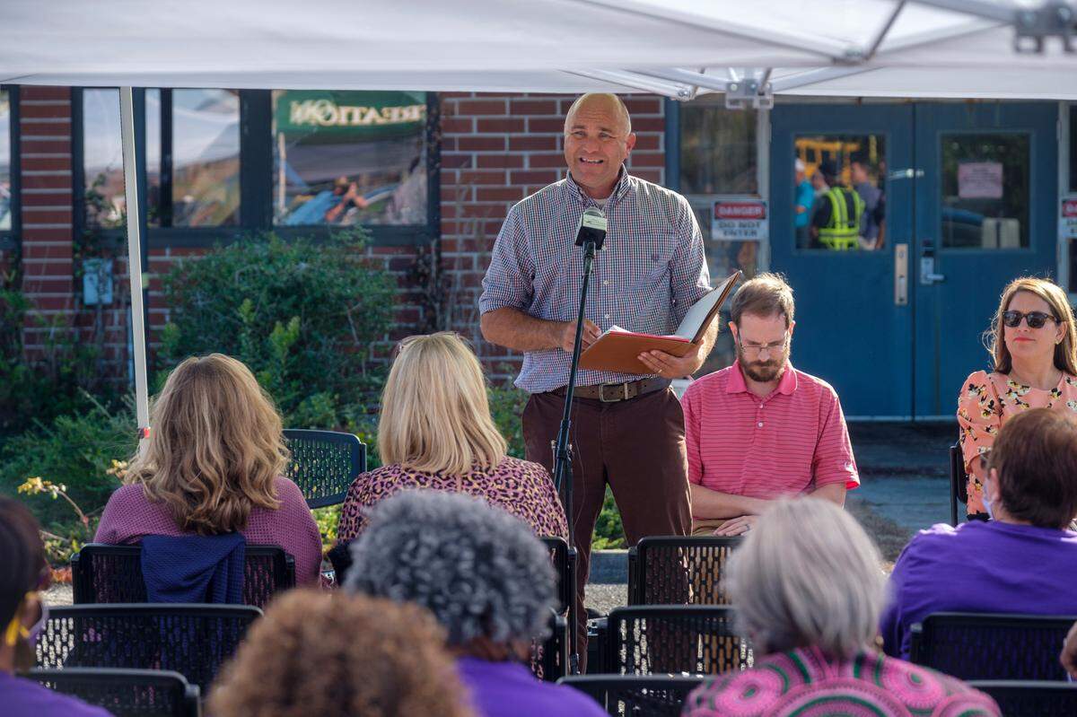 Members of the Conway community, many wearing school colors, listen to an explaination by Conway city administrator Adam Emrick of why the historically black Whittemore Elementary School will likely need to be demolished despite outspoken former students fighting for preservation. Oct. 27, 2021.