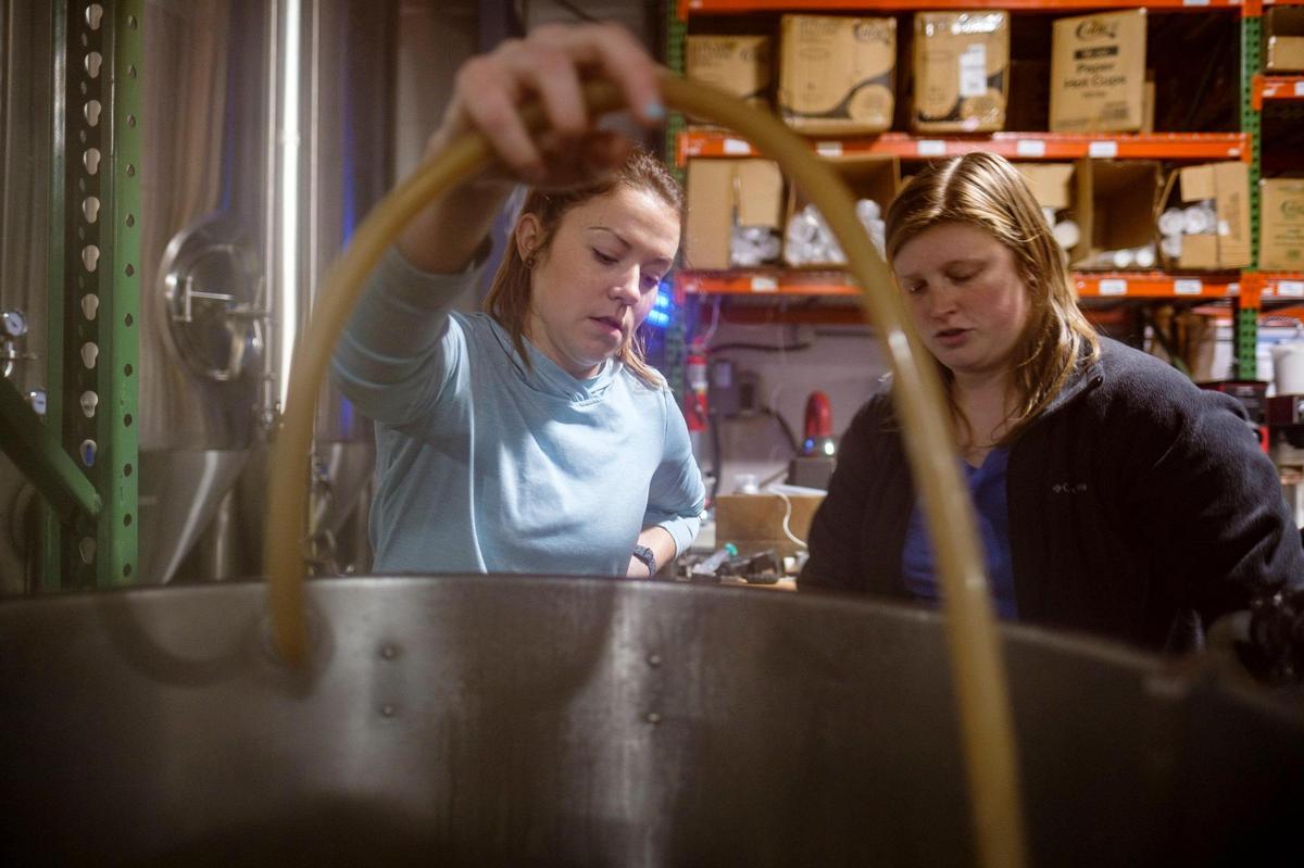 Female brewers Leah Antonelli, Jordan Skeen work brewing a Hazy Pale Ale called “Brave Noise.” on Tuesday, Dec. 21, 2021. The collaborative brew is a national movement to end sexism and discrimination in the brewing industry.