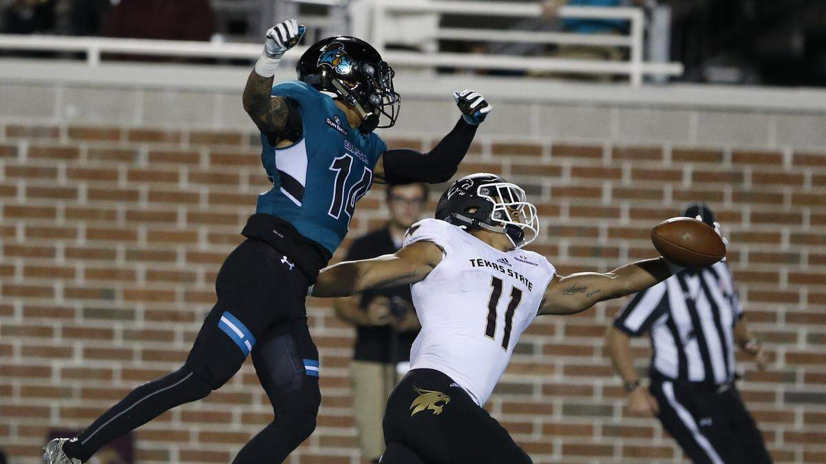 Texas State's wide receiver Eric Luna (11) just misses a pass in the end zone against Coastal Carolina defender Preston Carey (14) during the Chant's 27-7 loss October 27, 2017 at Brooks Stadium in Conway. -