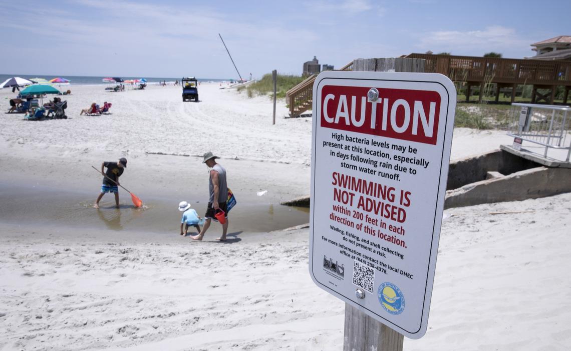 Children play in the Cane Patch Swash in Myrtle Beach. DHEC warns against swimming in swashes and in the outflow of storm water pipes. Long-term swim advisory signs are placed in many areas along the Myrtle Beach coast. June 28, 2018.