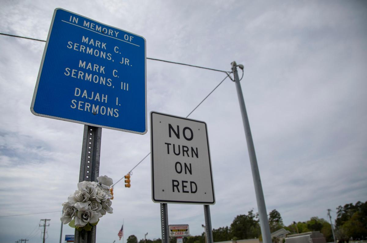 Flowers tied to a sign sit near a roadside memorial at the corner of Palmetto Pointe Blvd. and Hwy. 17 in Myrtle Beach.