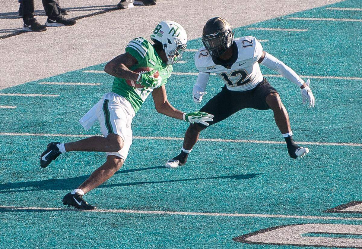 North Texas receiver Austin Ogunmakin (18) tries to run the ball against Appalachian State defensive back Steven Jones during App State’s 56-28 win in the inaugural Myrtle Beach Bowl at Brooks Stadium in Conway. Dec. 21, 2020.
